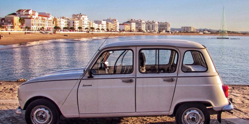classic-white-vintage-renault-4-savane-parked-by-european-beach-slow-travel-europe-itinerary-guide